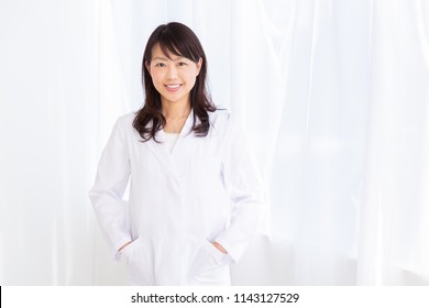 Asian Middle Age Woman In A White Coat