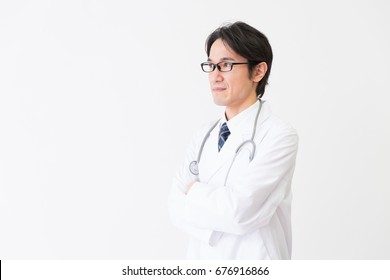 Asian Middle Age Woman In A White Coat,