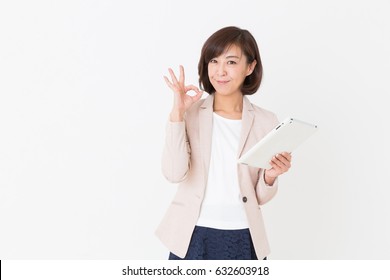 Asian Middle Age Woman Who Uses  Tablet Computer,