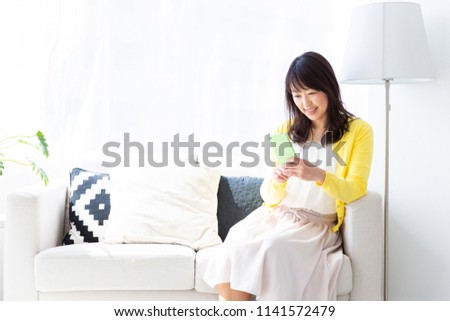 Asian middle age woman who uses smart phone