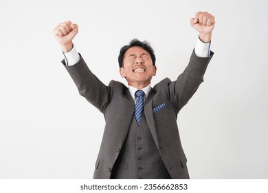 Asian middle aged businessman guts pose gesture in whited background - Shutterstock ID 2356662853