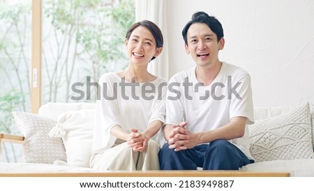 Asian middle aged couple in the room.