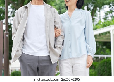 Asian middle aged couple taking a walk outdoor, no face