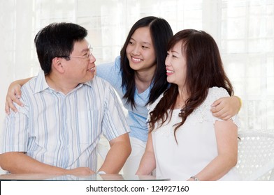 Asian Middle Aged Couple And Their Daughter