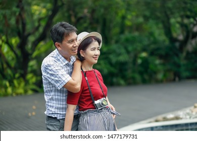 Asian Middle Aged Man Relaxing With His Wife In Anniversary Wedding Day