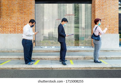 Asian Middle Aged People Wearing Mask And Keep Social Distancing To Avoid The Spread Of COVID-19