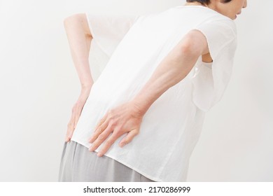 Asian Middle Aged Woman Having A Backache In White Background, No Face