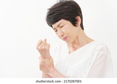 Asian Middle Aged Woman Having The Joint Pain In White Background