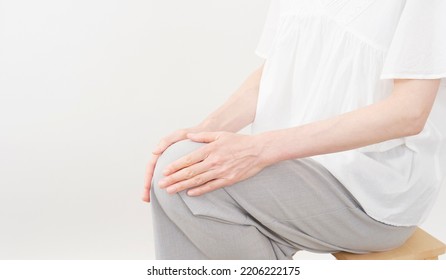 Asian Middle Aged Woman Having The Joint Pain In White Background, No Face