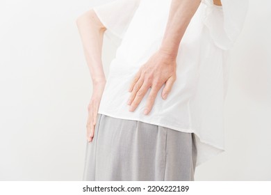 Asian Middle Aged Woman Having A Backache In White Background, No Face