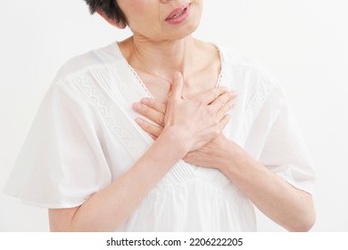 Asian Middle Aged Woman Having A Palpitation Of The Heart In White Background, No Face