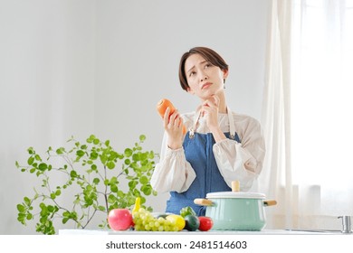 Asian middle aged woman having trouble in the kitchen - Powered by Shutterstock