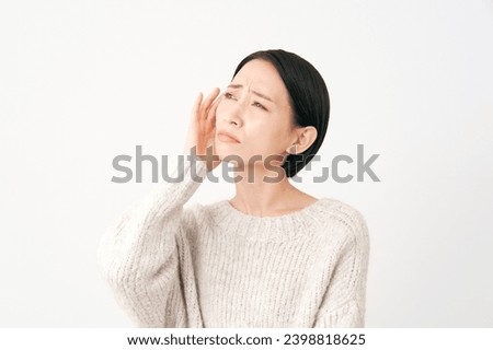 Asian middle aged woman having trouble in white background