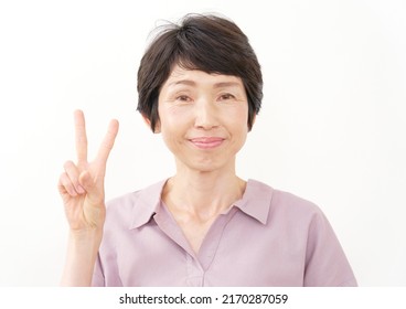 Asian Middle Aged Woman Peace Sign Gesture In White Background