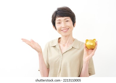 Asian Middle Aged Woman With The Piggy Bank In White Background