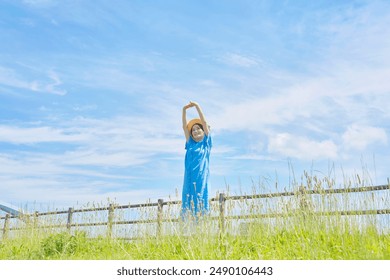 Asian middle aged woman relaxing outdoor - Powered by Shutterstock