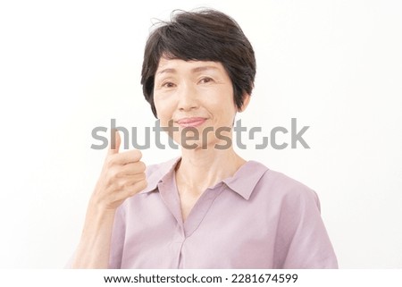 Asian middle aged woman thumbs up gesture in white background