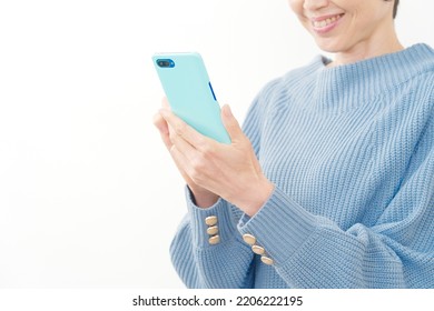 Asian Middle Aged Woman Using The Smartphone In White Background, No Face