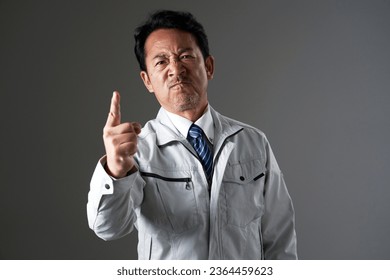 Asian middle aged worker in black background - Shutterstock ID 2364459623