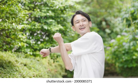 Asian middle man in the park - Powered by Shutterstock