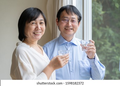 Asian Middle-aged Couple Drinking Water