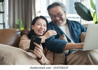 Asian Middle-aged Asian couple in living room at home - Powered by Shutterstock