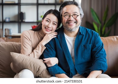 Asian Middle-aged Asian Couple Smiling At The Camera. Family Couple Portrait