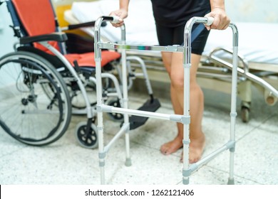 Asian middle-aged lady woman patient walk with walker at nursing hospital ward : healthy strong medical concept 
