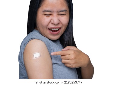 Asian Middle-aged Woman Feeling Pain And Arm Muscle Pain Ache, Having Some Side Effects After Receiving Getting Vaccinated Immunity With A Bandage On Her Upper Arm.  Healthy And Medical Concept