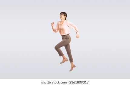 Asian middle-aged woman in a suit jumping energetically. - Powered by Shutterstock