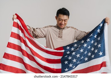 Asian Military Man Smiling While Posing With American Flag Isolated Over White Background