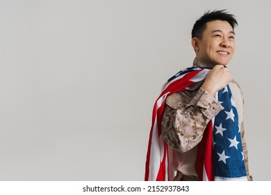 Asian Military Man Smiling While Posing With American Flag Isolated Over White Background