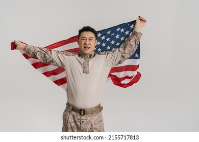 Asian Military Man Smiling While Posing With American Flag Isolated Over White Background