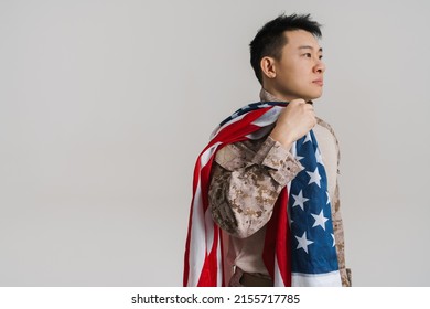 Asian Military Man Wearing Uniform Posing With American Flag Isolated Over White Background