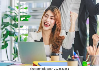 Asian Millennial Professional Successful Male Businessman Mentor In Black Formal Suit Standing Helping Two Female Employee Sitting Working With Laptop Computer At Workstation In Company Meeting Room.