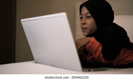 An Asian Model Show Her Impression While Looking At The Notebook And Not Looking At The Camera