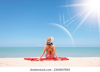 Asian model wear red swimsuit and straw hat sit on beach look view on hot day, Sun and UV rays hit the beautiful woman's protective layer. concept about of spa, sunscreen, cosmetics, health. - Powered by Shutterstock