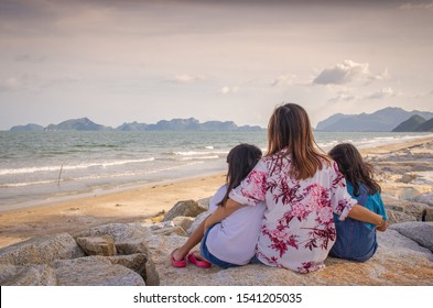 Asian Mom And Child Sad On Beach