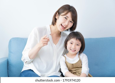 Asian Mom And Daughter Spending Time Indoors