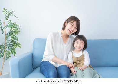 Asian Mom And Daughter Spending Time Indoors