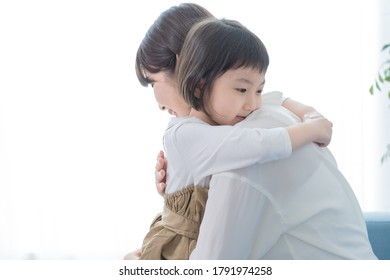 Asian Mom And Daughter Spending Time Indoors