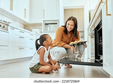 Asian, Mom And Girl In Kitchen At Oven, Baking And Cupcakes With Stove, Happy And Home. Mother, Child And Muffins For Learning, Education And Cooking In House For Skills, Love Or Bonding In Jakarta