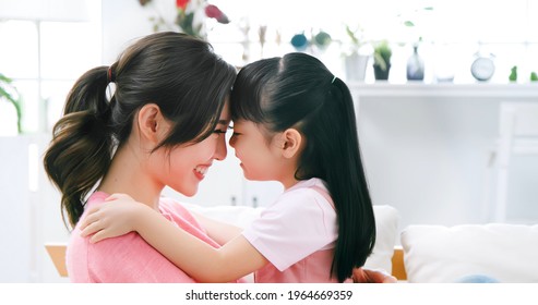 Asian Mom Hold Daughter In Her Arm And Child Smile Happily