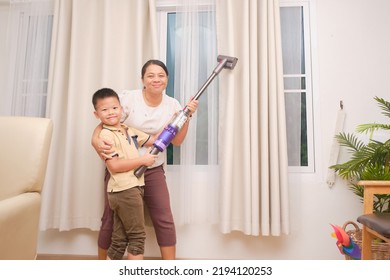 Asian Mom And Son Having Fun While Cleaning Up The Room Together, Mother And Her Kid Boy With Vacuum Cleaner At Home, Little Home Helper, Chores For Kids, Executive Functioning Skill Development