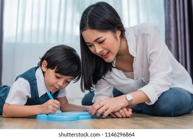 Asian Mom Teaching Cute Boy To Drawing In Chalkboard Together. Back To School And Education Concept. Family And Home Sweet Home Theme. Preschool Kids Theme.