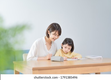 Asian mom teaching study in the room