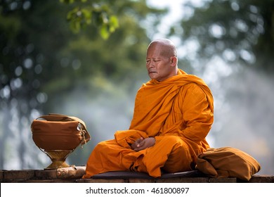 Asian Monk Meditating Under A Tree