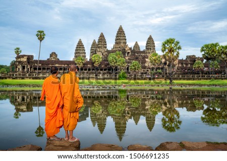 Asian monks stand and look to Angkor wat in siem reap, Cambodia, this image can use for travel and landmark in Asia