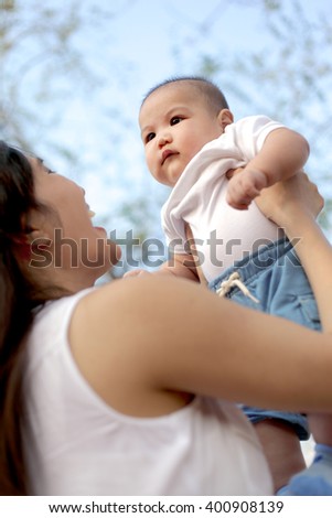 Asian Mother And Baby In The Park