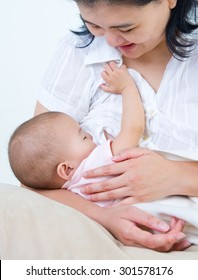 Asian Mother Breastfeeding Her Baby Girl